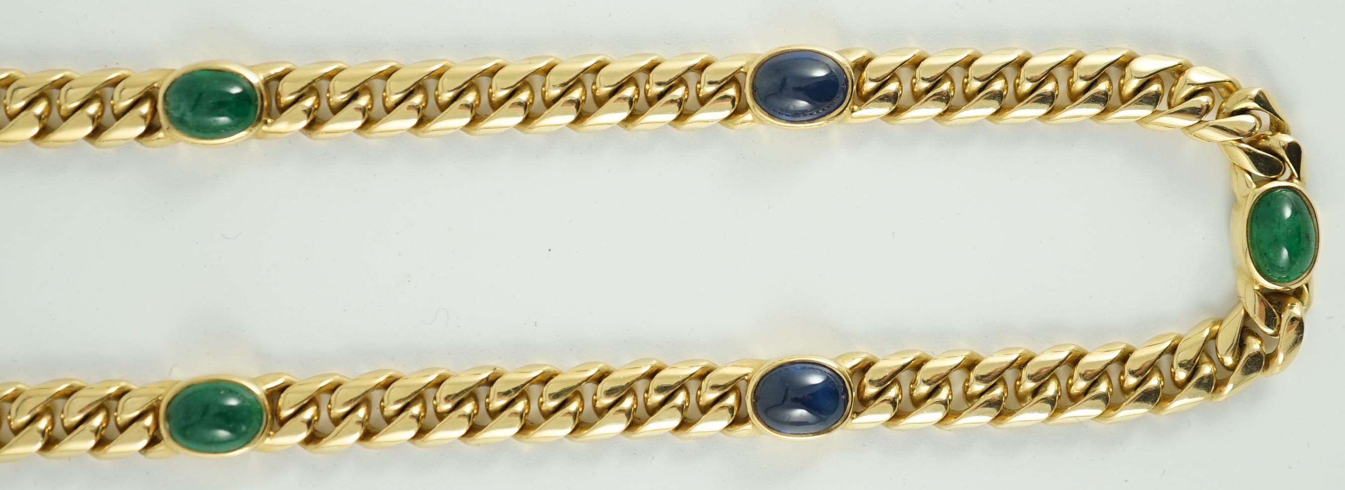 A modern 18ct gold, four stone cabochon sapphire and three stone cabochon emerald set curblink necklace